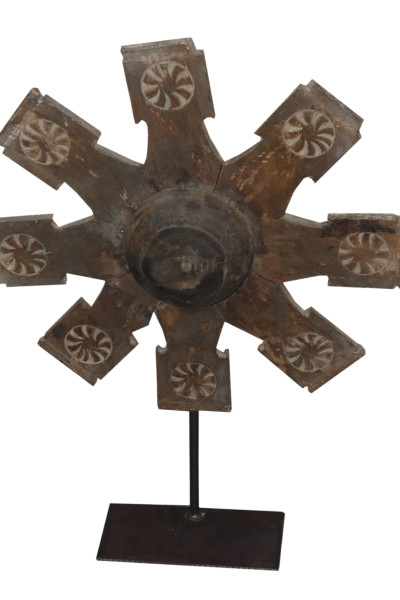 Old wheel pulley in wood on metal base. India