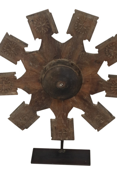 Old wheel pulley in wood on metal base. India